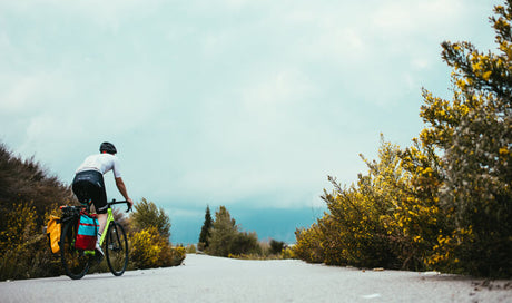 a cyclist wearing a helmet rides on the bike path