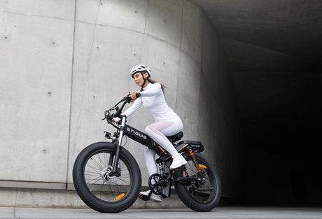 a woman rides a black engwe x24 24-inch fat tire electric bike
