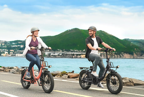 two people riding 2 engwe l20 2.0 cheap electric fat tire bikes on the road