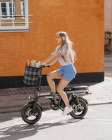 a girl rides a gray engwe t14 electric folding bike on the street