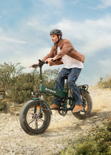 a man wearing a helmet rides a sea green engwe engine pro 2.0 on the gravel road