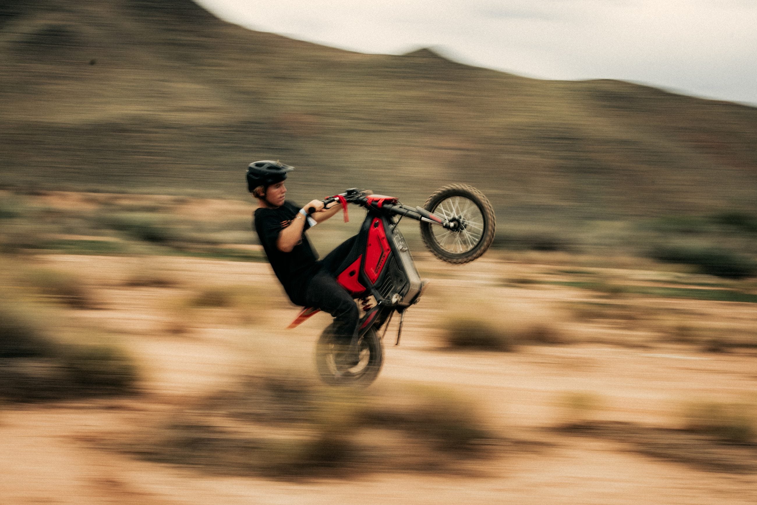 Rider performing a wheelie on a red ENGWE Eagle